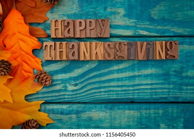 Happy Thanksgiving Background With Fall Leaves On Blue Wood