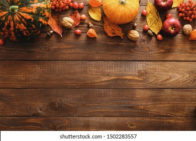 Happy Thanksgiving concept. Autumn composition with ripe orange pumpkins, fallen leaves, dry flowers on rustic wooden table. Flat lay, top view, copy space. - Shutterstock ID 1502283557
