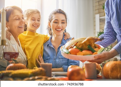 Happy Thanksgiving Day! Autumn feast. Family sitting at the table and celebrating holiday. Grandparents, parents and children. Traditional dinner. - Powered by Shutterstock