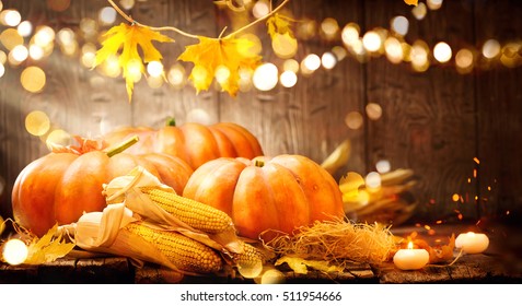 Happy Thanksgiving Day Background, Wooden Table Decorated With Pumpkins, Corncob, Candles And Autumn Leaves Garland. Beautiful Holiday Autumn Festival Concept Scene Fall, Harvest.