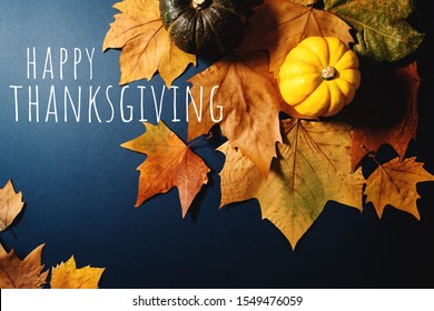 Happy Thanksgiving Day With Maple Leaves And Pumpkin On Blue Background