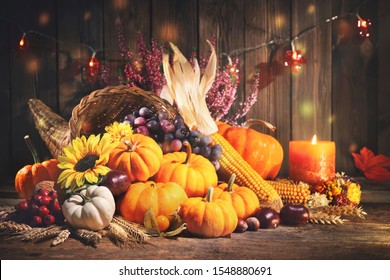 Happy Thanksgiving. Decorative Cornucopia With Pumpkins, Squash, Fruits And Falling Leaves On Rustic Wooden Table