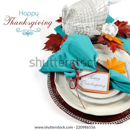 Happy Thanksgiving dining table place setting with vintage turkey tureen in Autumn brown and aqua color theme with copy space and sample text.
