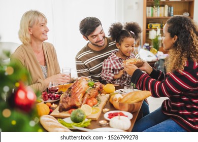 Happy Thanksgiving Dinner Party With Family And Food With Turkey On Table