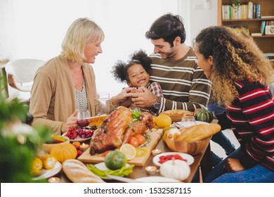 Happy Thanksgiving Dinner Party With Family And Food With Turkey On Table