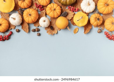 Happy Thanksgiving holiday background from autumn leaves, pumpkins and fall decorations on turquoise table top view. - Powered by Shutterstock