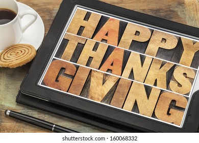 Happy Thanksgiving In Letterpress Wood Type On Digital Tablet Computer With Stylus Pen, Coffee Cup And Cookie