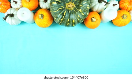 Happy Thanksgiving Setting Modern Elegant Blue Orange And White Themed Table With Pumpkins Centerpiece Overhead Flat Lay With Negative Copy Space.