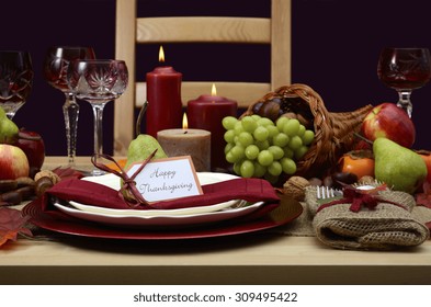 Happy Thanksgiving Table Setting In Classic Rustic Colors On Wood Table With Cornucopia Centerpiece, Candles And Fruit. 