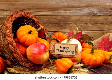 Happy Thanksgiving Tag And Cornucopia With Autumn Fruit And Vegetables On Rustic Wood Background