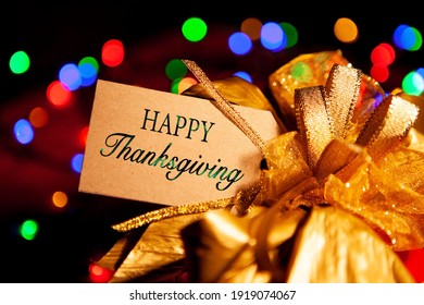 Happy Thanksgiving - Text On A Gift Box Label With A Large Gold Bow. 