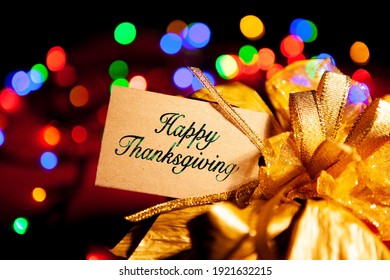 Happy Thanksgiving - Text On A Gift Box Label With A Large Gold Bow. 