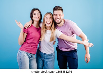 happy three friends man and women on blue background
