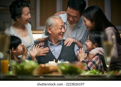 happy three generation asian family celebrating grandpa's birthday at home - Powered by Shutterstock