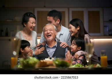 happy three generation asian family celebrating grandpa's birthday at home - Powered by Shutterstock