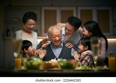 happy three generation asian family celebrating grandpa's birthday at home - Powered by Shutterstock
