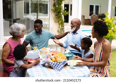 Happy three generational african american family enjoying brunch at backyard. family, love and togetherness concept, unaltered.