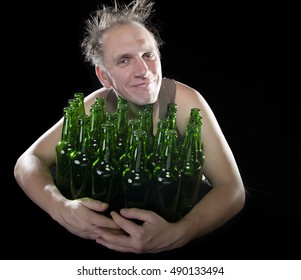 The happy tipsy man near empty beer bottles