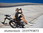 Happy tired sportsman resting enjoying refreshing time during cycling training