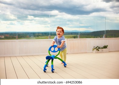 Happy Toddler Baby Boy Pushing Pushing Go Cart, Outdoors