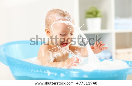A Happy toddler bathing in bathtub