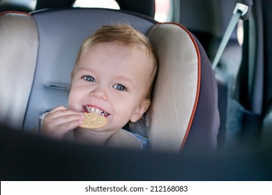 Happy Toddler Boy In The Car Eating Cookies