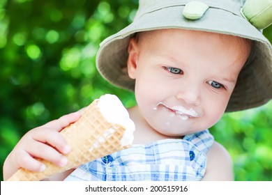 Happy Toddler Boy Eating Ice Cream On A Summer Day