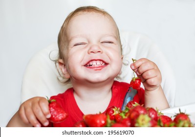 Happy Toddler Boy Eating Strawberries On A White Background