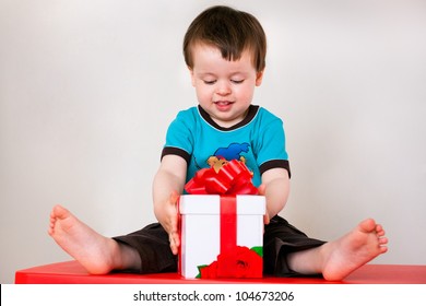 Happy Toddler Boy Opening Gift Box