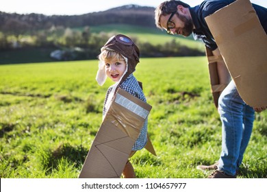 Happy Toddler Boy Playing Outside With Father In Spring Nature.