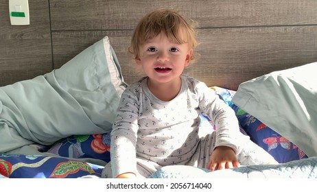 Happy Toddler Boy Playing Peekaboo, Baby Plays Hide And Seek Under Bed Blankets