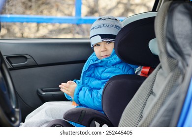 Happy Toddler Boy Sitting In The Car Seat