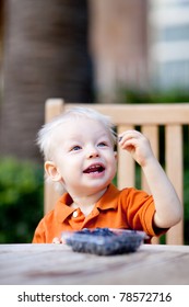 Happy Toddler Eating Blueberries