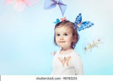 Happy toddler girl over blue background