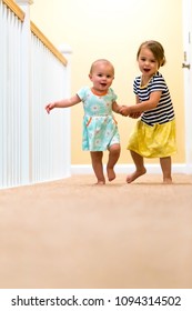 Happy Toddler Girls Running And Playing Indoors