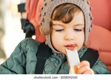 Happy Toddler Kid Eating Fruit Bar, Healthy Snack, Sitting In Stroller