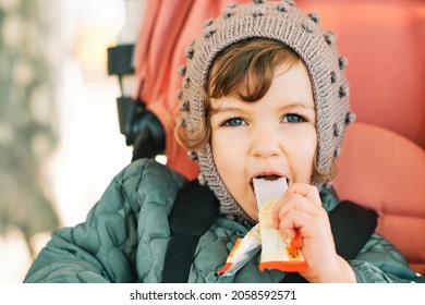 Happy Toddler Kid Eating Fruit Bar, Healthy Snack, Sitting In Stroller