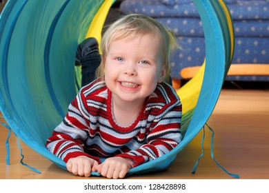 Happy Toddler Plays Indoor In A Tunnel