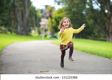 Happy Toddler Running In The Park