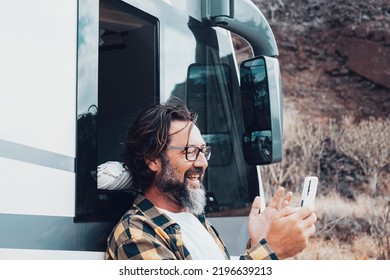 Happy Tourist With Camper Van Use Mobile Phone To Call And Speak Remote Friends With Voice And Internet Connection In The Country Side. Roaming Online Technology And Travel Lifestyle People