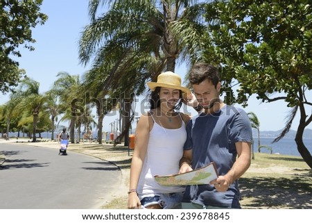 Happy tourist couple with map