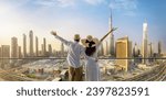 A happy tourist couple on vacation time stands on a balcony and enjoys the panoramic view of the Dubai city skyline, UAE