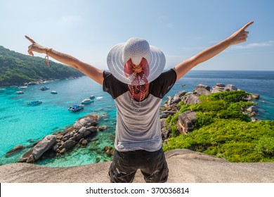 Happy tourist enjoys panorama from Sail Rock View Point of kor 8 of Similan Islands National Park, Phang Nga, Thailand, one of the tourist attraction of the Andaman Sea.