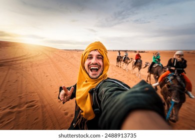 Happy tourist having fun enjoying group camel ride tour in the desert - Travel, life style, vacation activities and adventure concept - Powered by Shutterstock