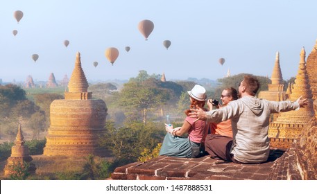 Happy Tourists, Friends, Vacationers In The Summer Holidays In Old Bagan, Myanmar.
Young People Having Fun Traveling Together. Travel, Holiday, Relationship And Sport Concept.