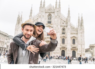 Happy Tourists Taking A Self Portrait With Phone In Front Of Duomo Cathedral,Milan - Couple Traveling In Italy