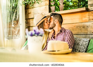 Happy Travel Couple Having Tender Moments In Bar Restaurant - Young Lovers Kissing On Summer Vacation - Love Relationship Concept - Focus On Man And Woman Faces