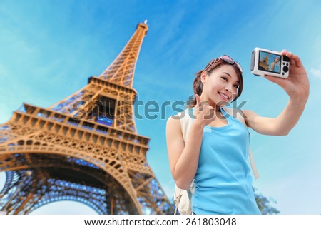 Happy travel woman in Paris with Eiffel Tower and she take a selfie picture, asian beauty