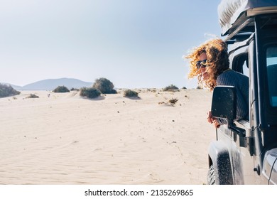 Happy Travel Woman Smile And Enjoy Outdoors Outside Her Black Parked Off Road Car. Summer Vehicle Holiday Adventure. Alternative Tourist In The Desert With All Terrain Vehicle. People Lifestyle