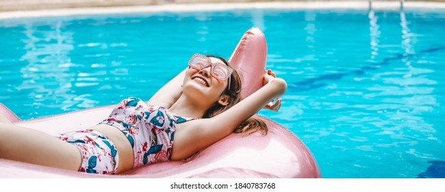 Happy traveler asian woman with bikini relax on big pink flamingo pool float in swimming pool at Thailand, summer travel vacation concept - Powered by Shutterstock